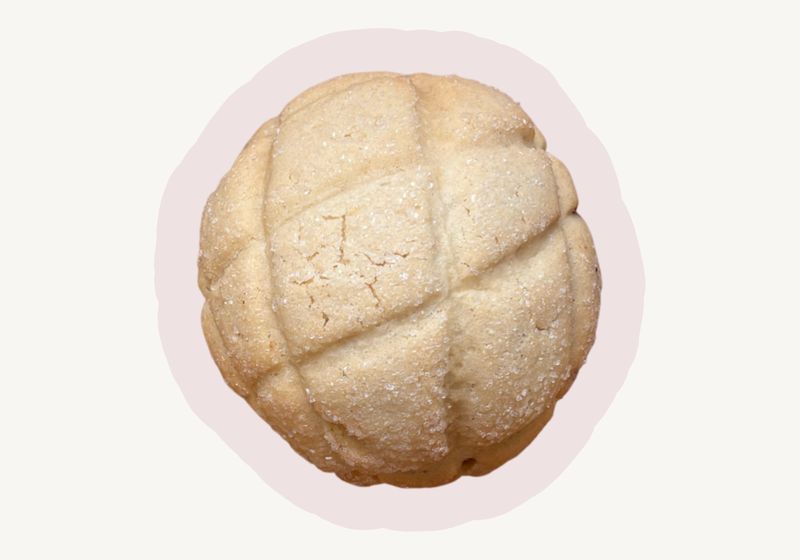 Melon pan with a crackled, sugar-crusted cookie top